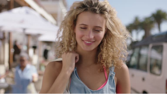 Woman rocks effortless curls on a trip, achieved with a heatless hair curler for travel-friendly styling