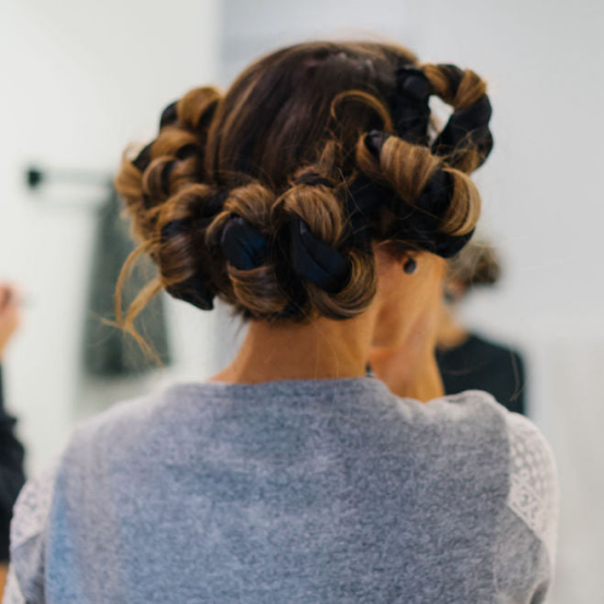 Using a heatless hair curler for Instagram-ready waves.