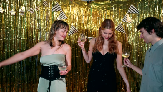 Women at a party with bouncy, glamorous curls, showing how a heatless hair curler creates party-ready styles.